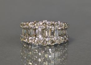 AN IMPRESSIVE DIAMOND RING, set row of baguettes between two rows of brilliant-cut stones, total