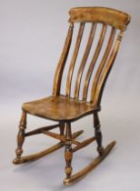 A 19th century elm, beech & grained wood lath-back rocking chair with hard seat & turned supports,