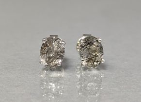 A pair of ear-studs set oval-cut rutilated quartz to silver mounts.