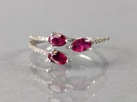 A ruby & diamond ring, the split shank set three oval-cut rubies & numerous rose diamonds, 1.5g,