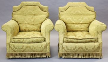 A pair of early/mid-20th century upholstered armchairs, each covered in gold floral damask with shap