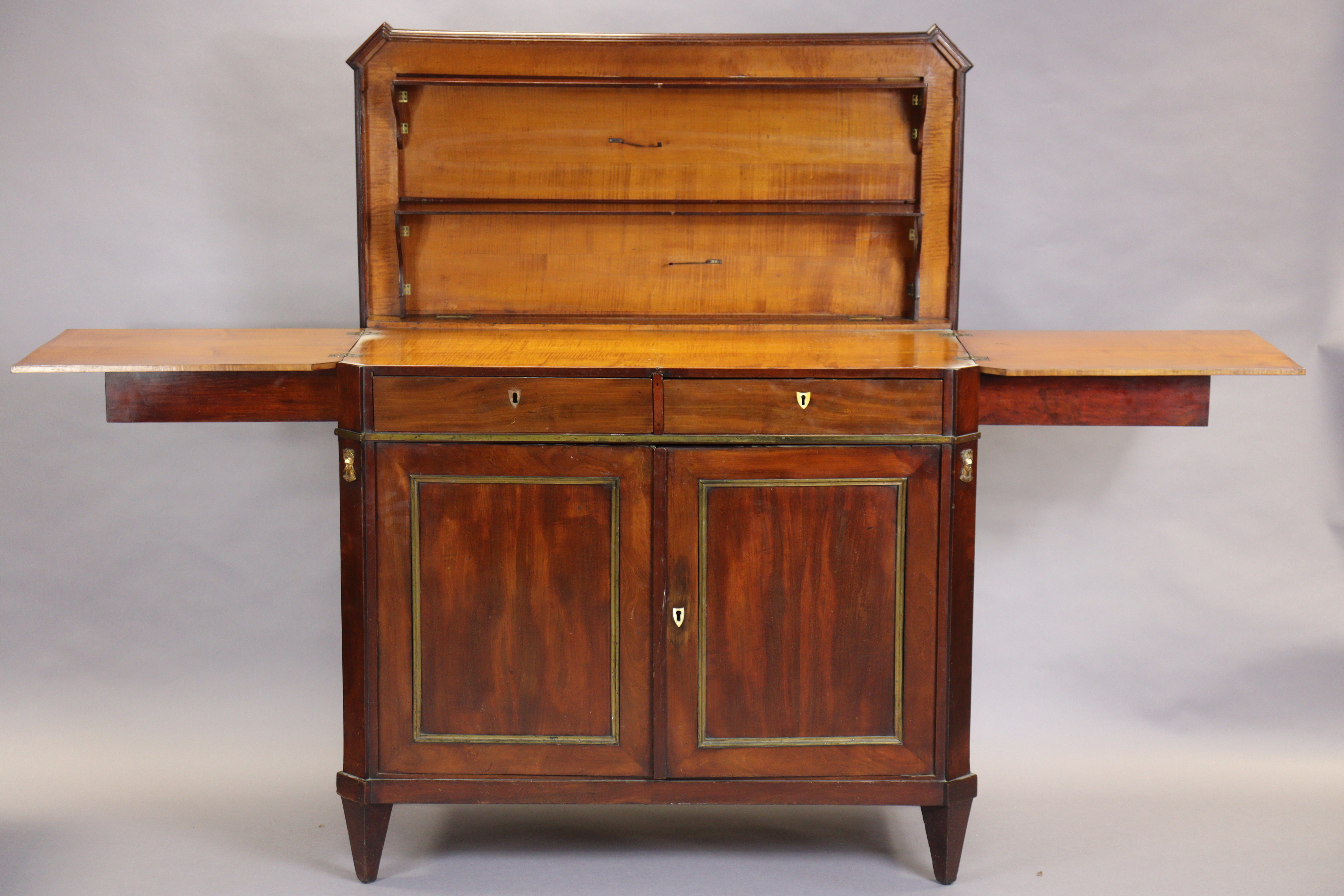 An early 19th century French mahogany buffet, the hinged top enclosing folding shelves, two frieze - Image 2 of 14