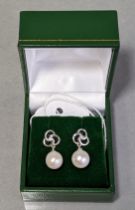 A pair of cultured pearl & diamond earrings, each approx 88mm, suspended from a diamond-set white