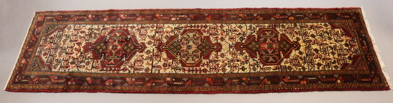 A northwest Persian Malayer runner of madder ground with repeating geometric design and multiple