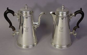 A pair of George V silver café-au-lait jugs in the early 18th century style, of plain round