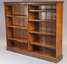 A Victorian mahogany standing open bookcase of two divisions, the adjustable shelves with leather