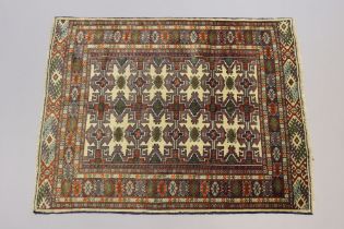 A northeast Persian Turkoman rug of ivory ground with rows of repeating geometric designs surrounded