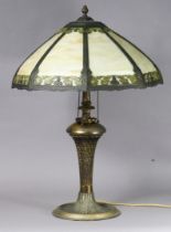 A 20th century bronzed metal table lamp inset opaque glass panels to the foliate shade, on spiral-