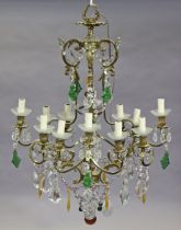 A 20th century gilt-metal four-branch electrolier, hung with glass prism drops, each branch with