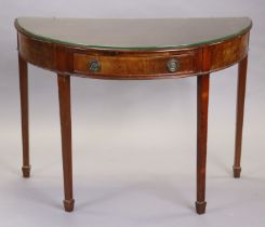 A Georgian mahogany demi-lune side table fitted frieze drawer with brass ring handles, on square