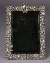 A late Victorian, large rectangular dressing table mirror, the wide silver-mounted border