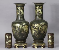 A pair of late 19th/early 20th century Japanese black lacquer ovoid vases, each with all-over gilt