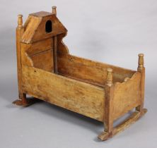 A late 18th/.early 19th century fruitwood cradle, with open recess canopy & shaped sides, on