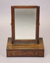 A Georgian mahogany swing toilet mirror with tapered supports and box base fitted long drawer with