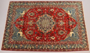 A central Persian Isfahan rug of madder ground with a central medallion surrounded by flowers &