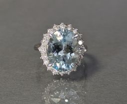 AN AQUAMARINE & DIAMOND RING, the large oval-cut aquamarine weighing 5.61 carats, set within a