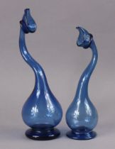 Two 20th century blue glass rosewater sprinklers, each on round foot, 24cm & 28cm high.