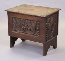 A late 19th century oak small coffer with carved leaf-scroll panels & border, with hinged lift-