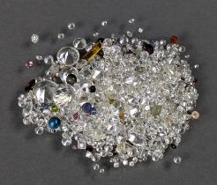 A quantity of loose mixed-cut gemstones, including sapphire, ruby, garnet, quartz, etc.