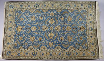 A Turkish rug of pale blue & ivory ground with repeating multi-coloured foliate design to centre