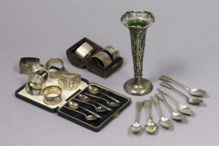 An Edwardian silver spill vase inset with a green glass liner & on a round pedestal foot, 19.5cm