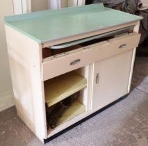 A mid-20th century white painted wooden kitchen side cabinet with a hinged frieze concealing a