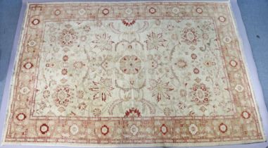 A small carpet of cream ground & with all-over repeating multi-coloured foliate design to centre