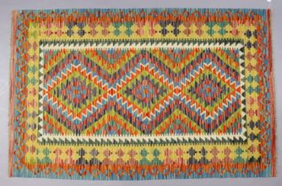 A Chobi Kilim rug with repeating multi-coloured geometric design to centre within a wide border,