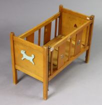 A vintage Tri-ang wooden dolls cot, 85cm wide x 49.5cm high.
