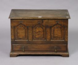 An antique-style oak small coffer or coffer bach, with a hinged lift-lid, enclosed by a fielded
