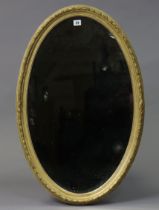 Another late 19th/early 20th century gilt frame oval wall mirror with a raised foliate border &