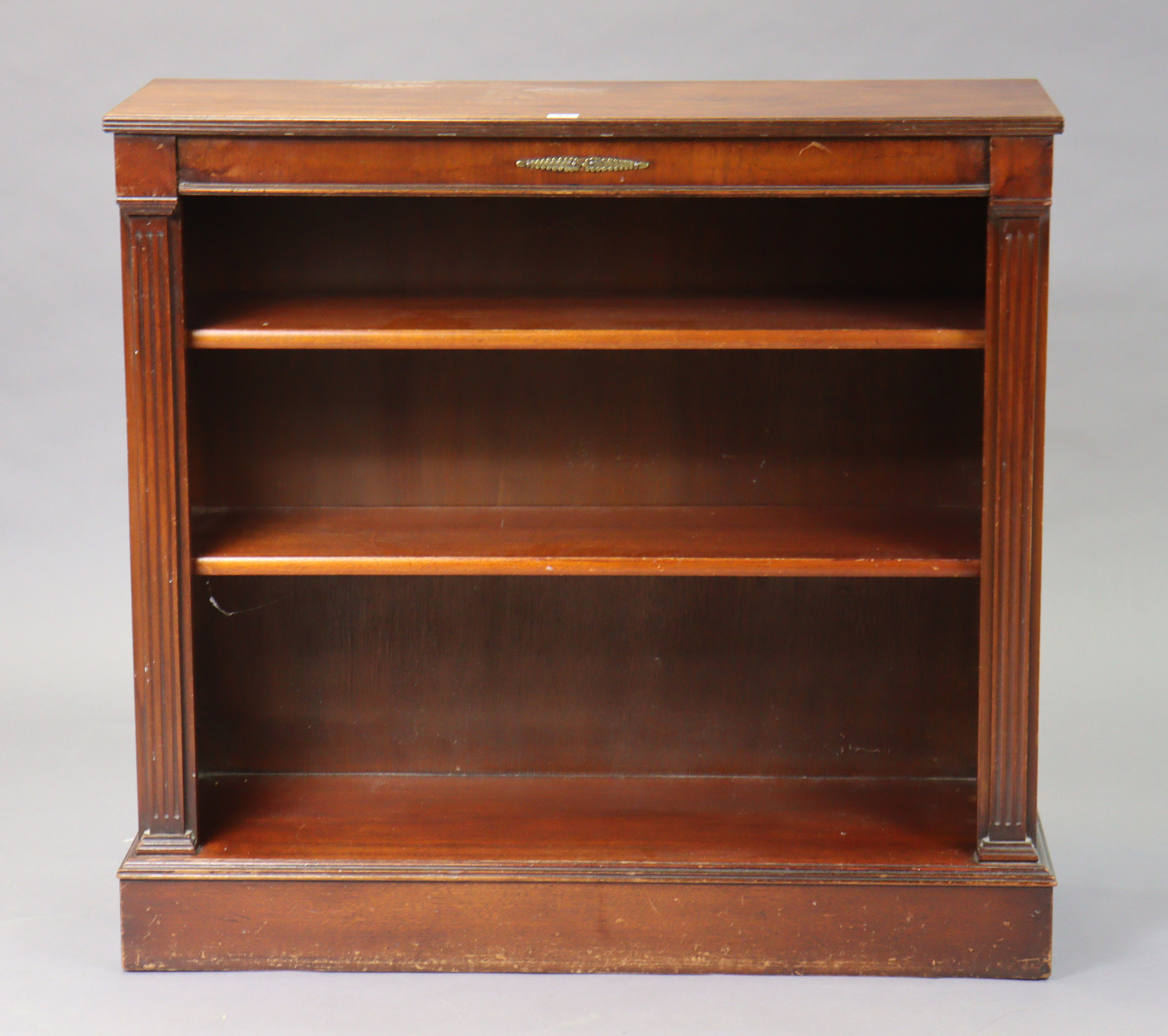 A 19th century-style mahogany small standing open bookcase with two adjustable shelves, & on a