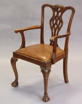 A 19th century Chippendale-style mahogany elbow chair with carved & pierced splat back, tan-