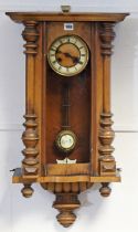 A Vienna-type wall clock with a two-part dial, & in a walnut case, 77cm high (w.a.f.).