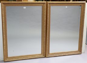 Another pair of gilt frame rectangular wall mirrors each with a raised scroll border, & inset with a