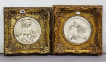 Two composition roundels each depicting children in relief, 17cm diameter, in similar gilt frames,