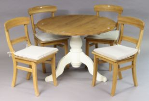 A pine circular dining-table on a white painted vase-turned centre column & three cabriole legs,