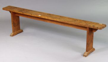 A French provincial pine long bench on square end supports, 185cm long x 47cm high x 17.5cm deep.