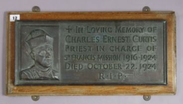 A 1920’s bronzed rectangular memorial plaque “IN LOVING MEMORY OF CHARLES ERNEST CURTIS PRIEST IN