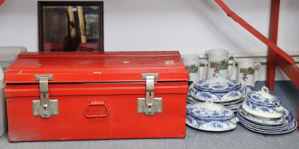 A red painted metal travelling trunk with a hinged lift-lid & with wrought-iron side handles, 73cm