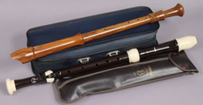 A Yamaha plastic tenor recorder; & a wooden tenor recorder, both cased.