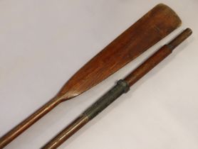 A pair of vintage wooden rowing oars with steel collars, each 182.5cm long.