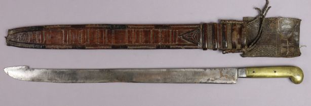 An African short sword having a 53.75cm long single-edge curved blade, with a brass grip & with a