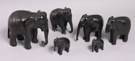 Six carved ebony graduated elephant ornaments; four die-cast scale model vehicles; & a Dunlop “