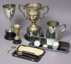 A George VI silver teaspoon, Birmingham 1938, cased; three silver plated trophy cups, one with a