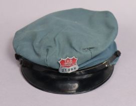 A vintage T. R. B. Metropolitan bus driver’s peak cap with an enamelled cap badge (No. 21388).