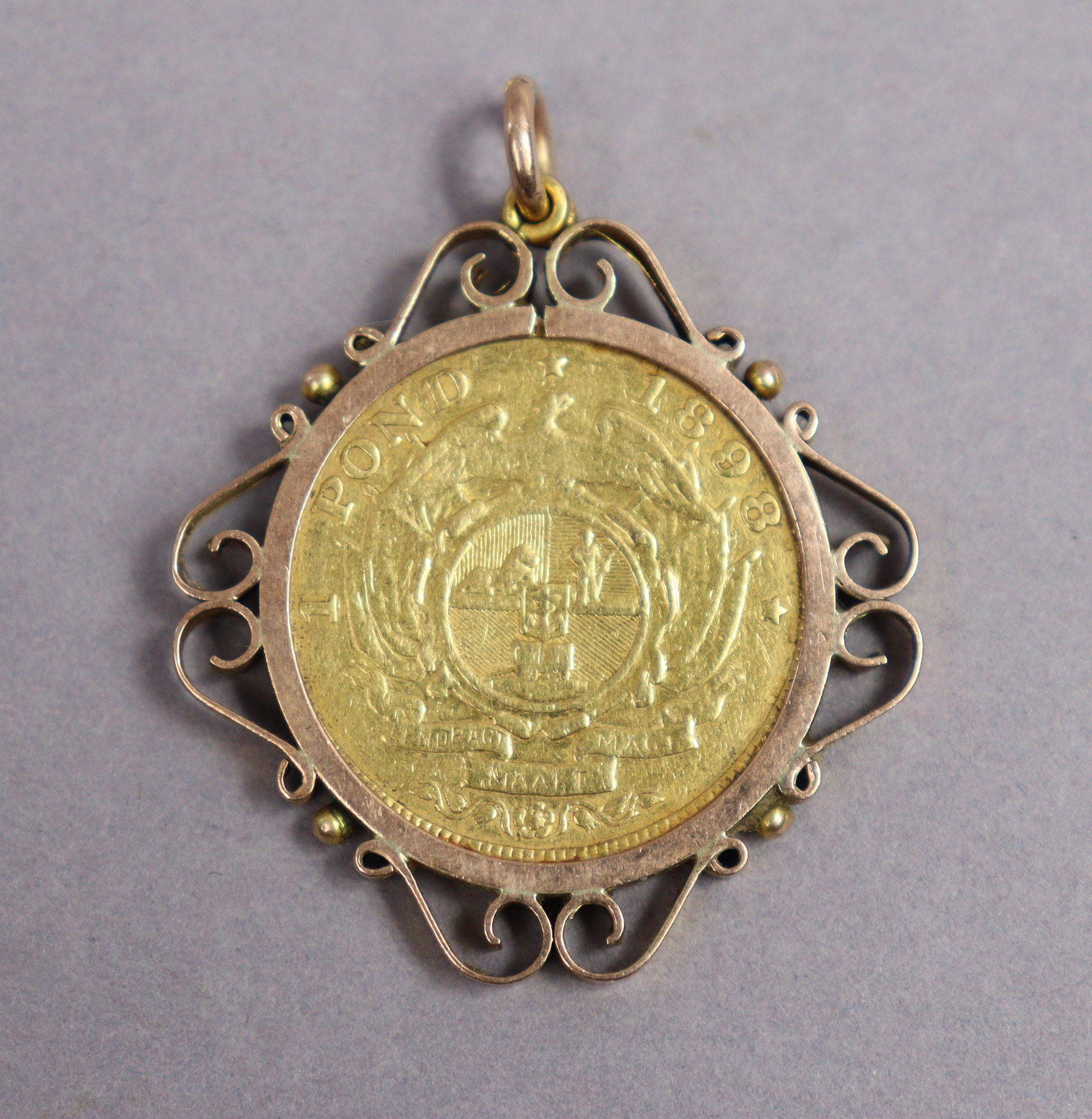 A South African gold 1 Pond coin, 1898; forming a pendant with 9ct. scroll mount.