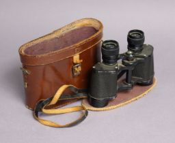 A pair of French black-lacquered field glasses with case.