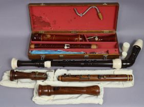 A Yamaha plastic bass recorder; & two wooden bass recorders; two cased.