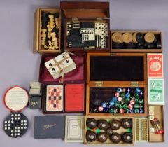 A set of carved wooden travelling chessmen (size of kings 5.75cm high); a set of dominoes; a set